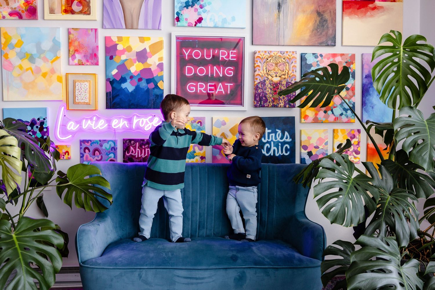 Colorful wall gallery with inspirational quotes and plants creating vibrant office space.