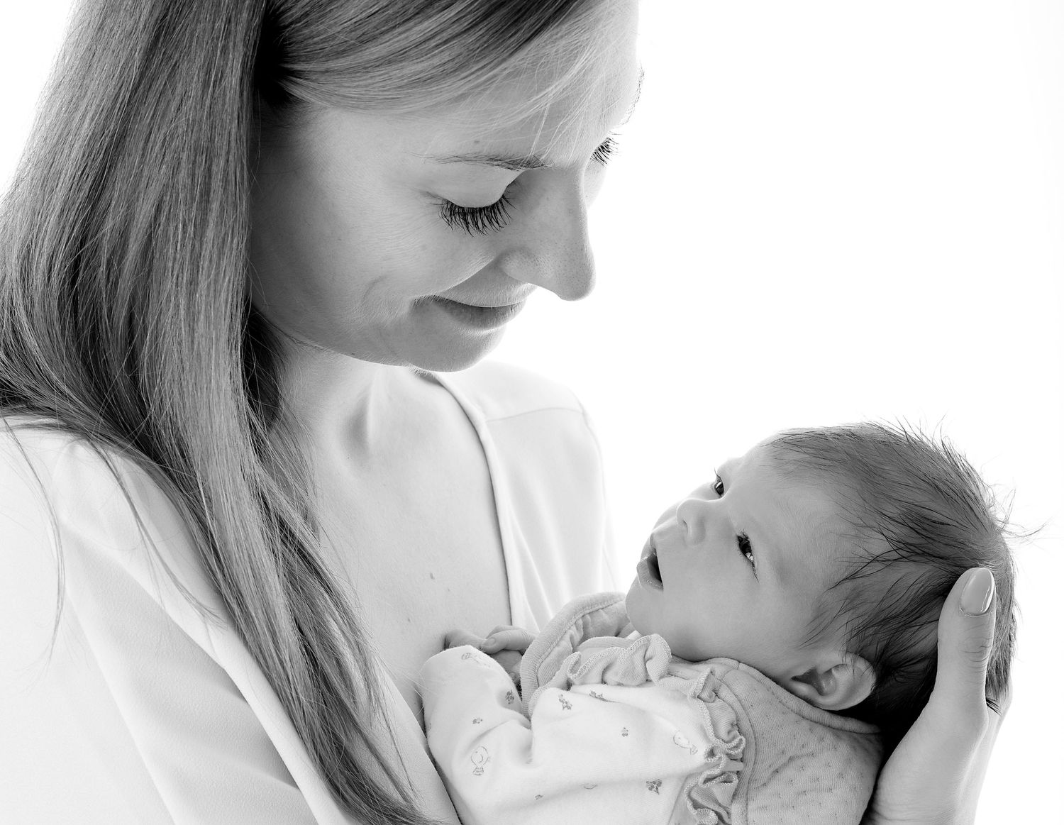 A tender black and white series showing a mother holding and bonding with her newborn baby.