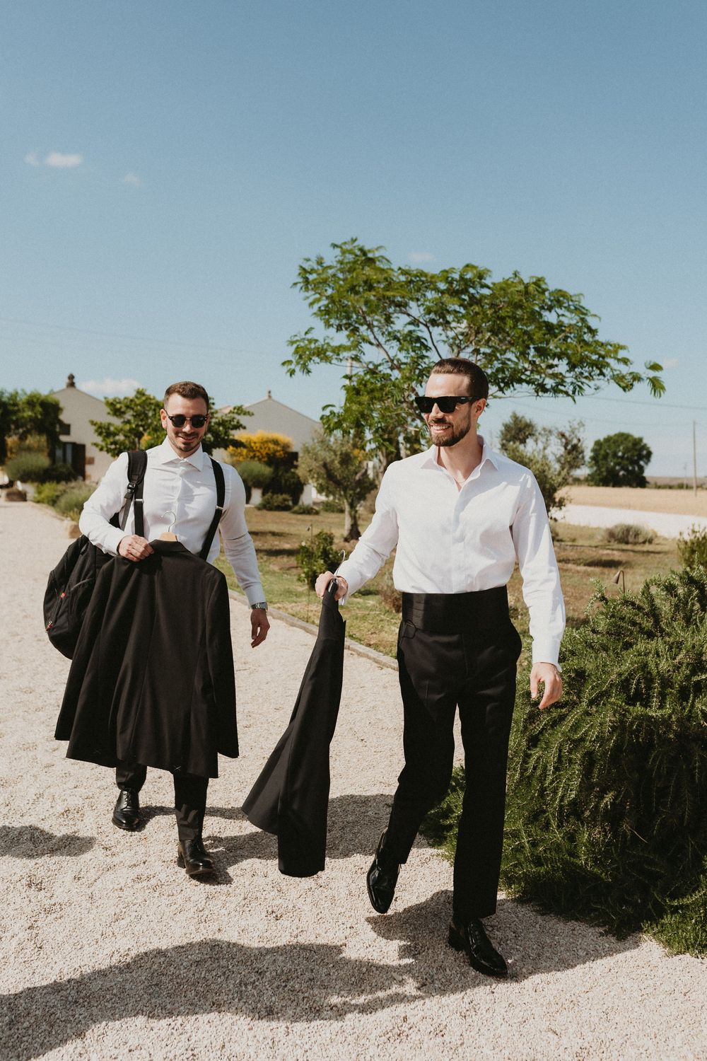 A sequence of images showing someone walking while carrying a black suit jacket in an outdoor desert setting.