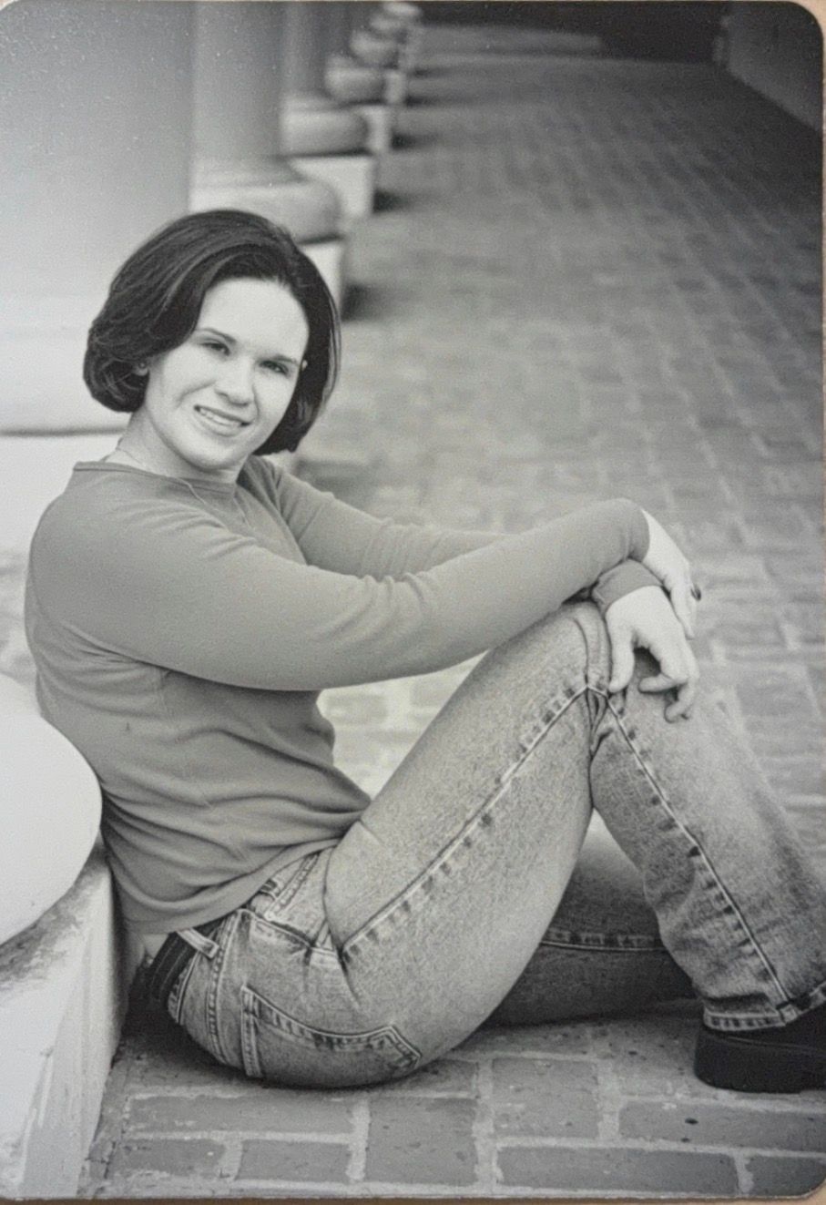 Black and white photo series showing a person in jeans and sweater sitting casually on brick pavement in various poses.