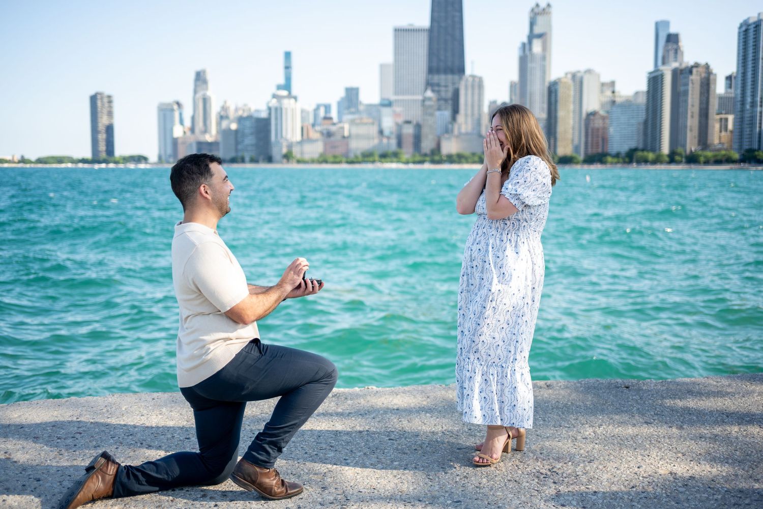 A romantic proposal moment unfolds along Lake Michigan with the Chicago skyline in the background.