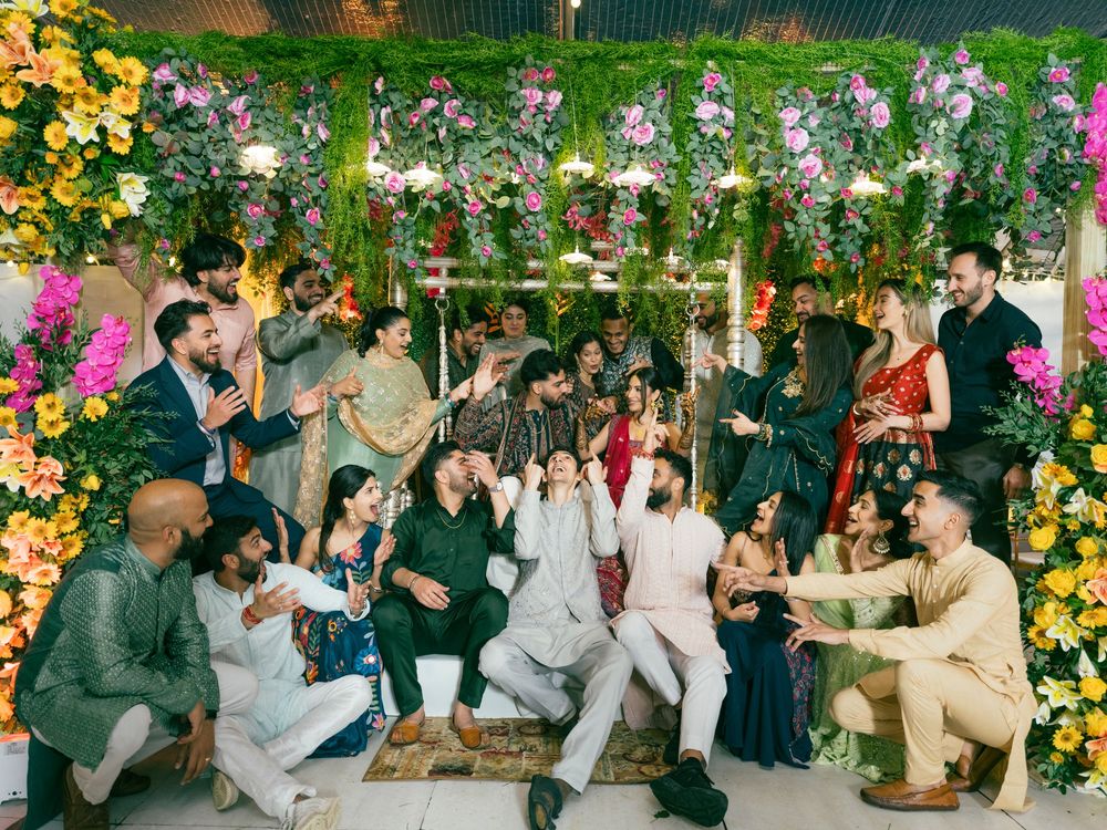 Wedding celebration with floral decorations and guests dancing in an outdoor venue.
