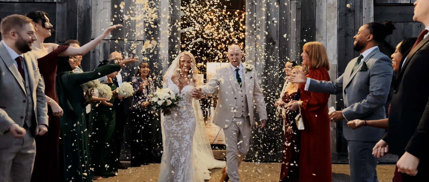Wedding party celebrates with sparklers during an evening reception creating magical light trails.