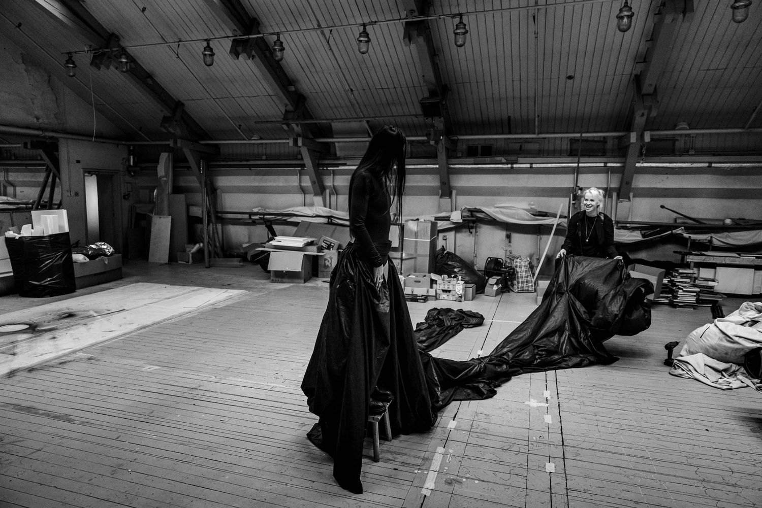 Black and white photo of a photographer at firs ballet studio for Elza Leimane.  beautiful skirt from show Crow