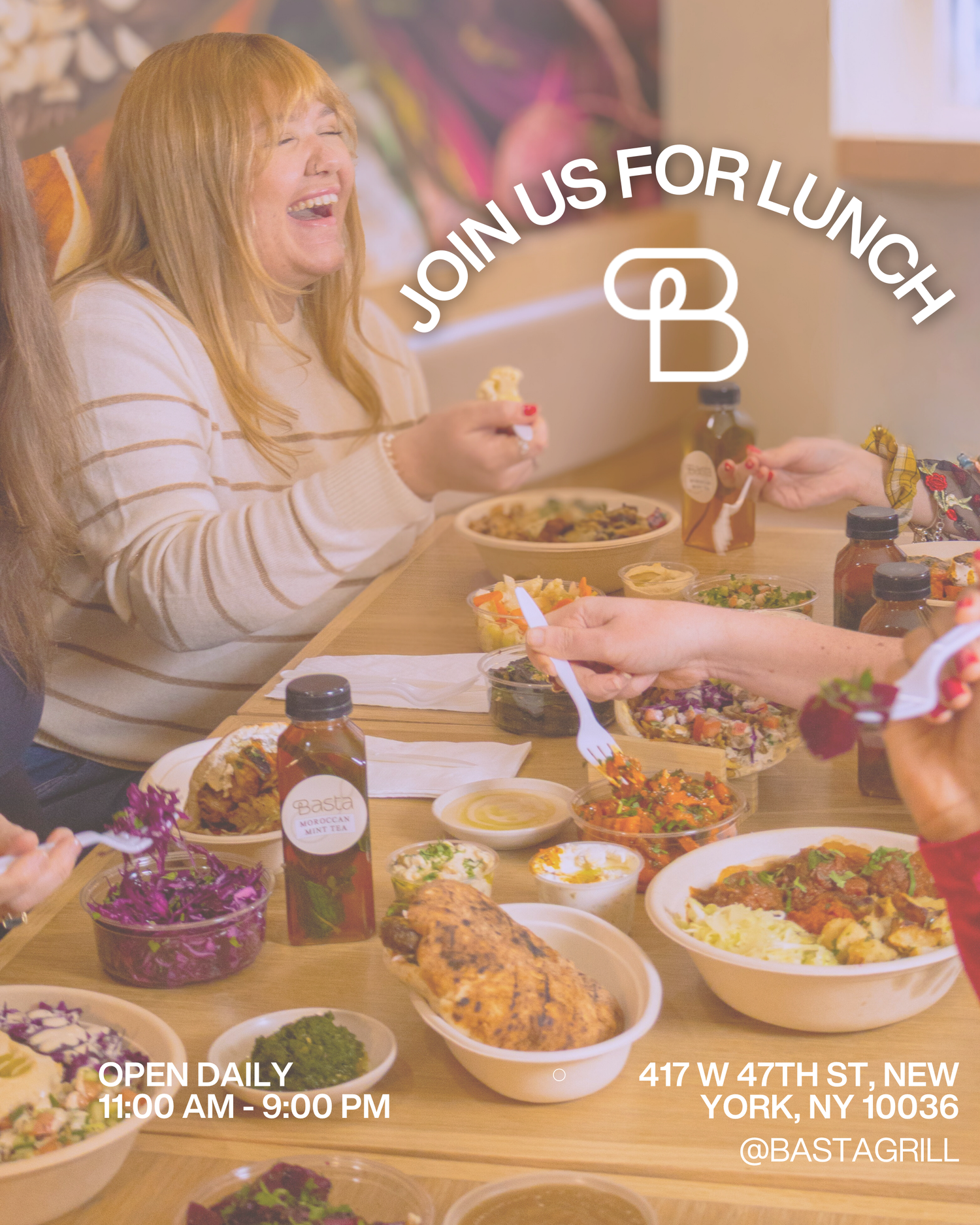 Woman laughing while dining with friends at Basta Grill NYC, open daily 11AM-9PM on W 47th St.