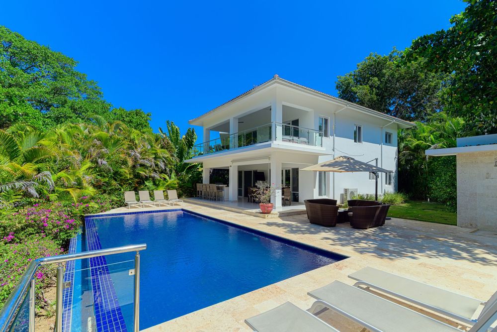 Ocean view Sosua villa for sale featuring BBQ by the pool, quartz pool bar, and mini fridge.