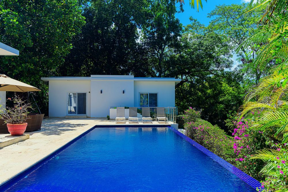 Luxury 6-bedroom villa with ocean view, tropical greenery, and full-service in-house laundry.