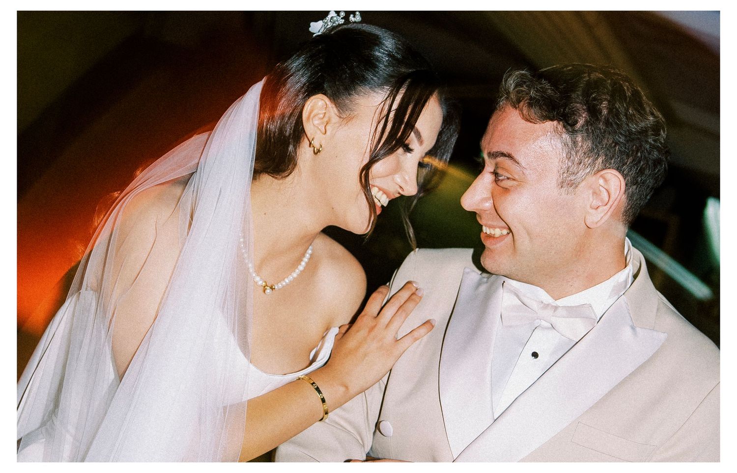 A couple in wedding attire share intimate moments during their celebration in a series of candid photographs.