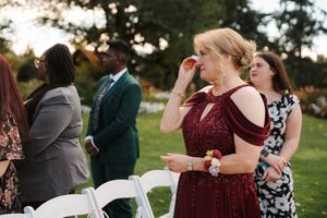 Wedding guests dance and celebrate together on an outdoor dance floor during a reception celebration.