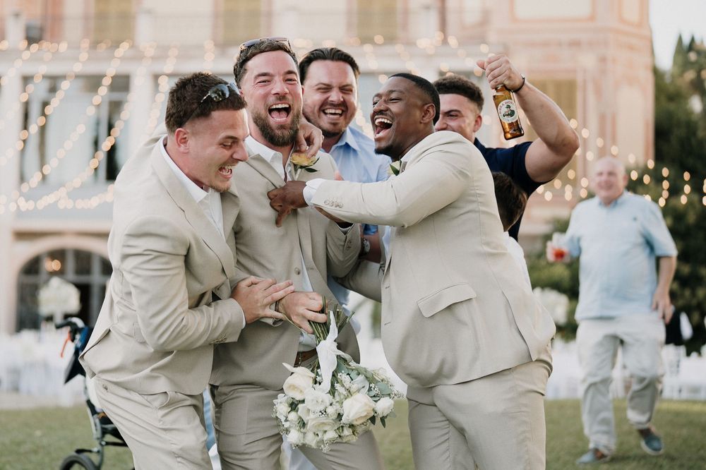 Friends of the groom with bouquets in front of Villa Nobel during the wedding in Sanremo