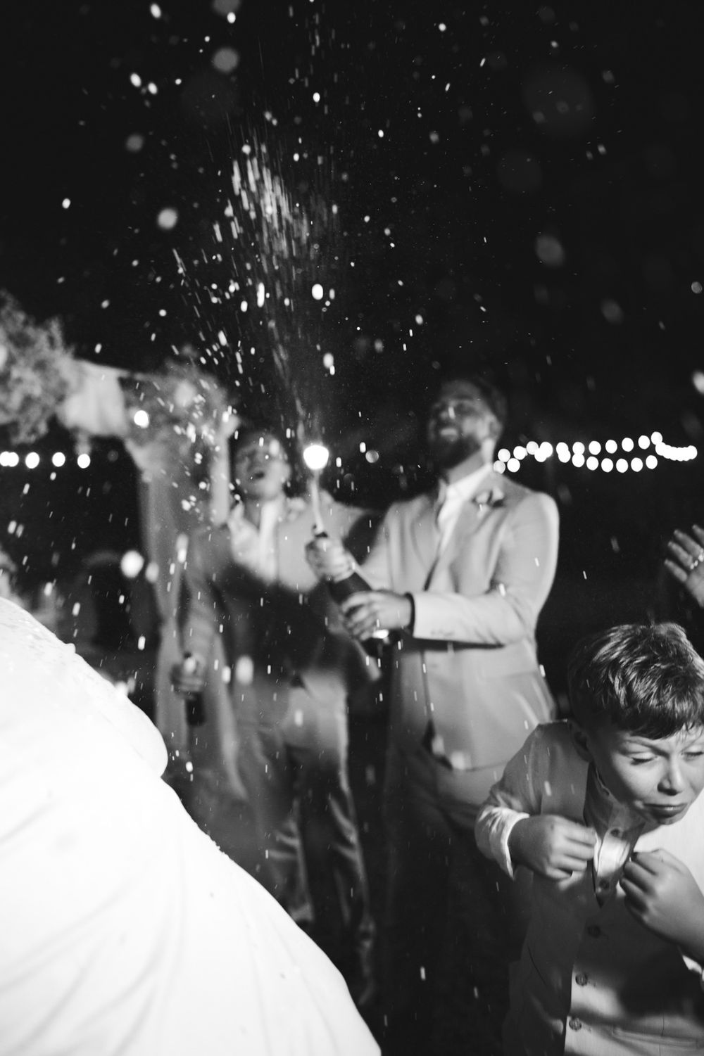 Newlyweds popping champagne during their wedding reception at Villa Nobel in Sanremo.
