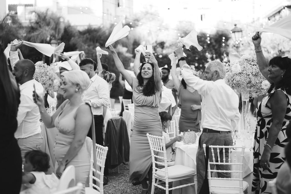 Guests raising napkins during the wedding reception at Villa Nobel in Sanremo.