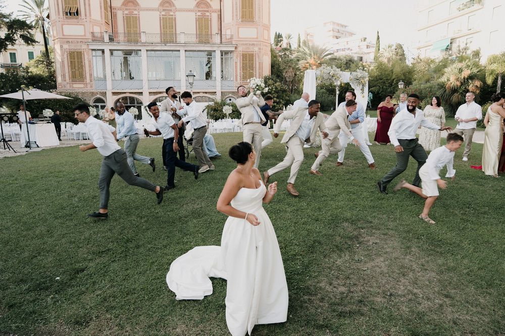 Guests competing for the bouquet during the wedding at Villa Nobel Sanremo.