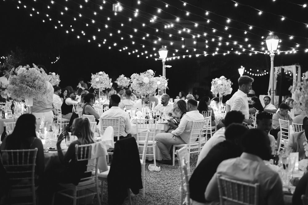 An outdoor evening reception with fairy lights in the garden of Villa Nobel in Sanremo.