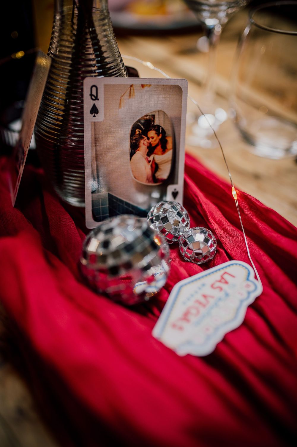 Playing cards and decorative elements arranged on a red velvet surface with vintage styling.