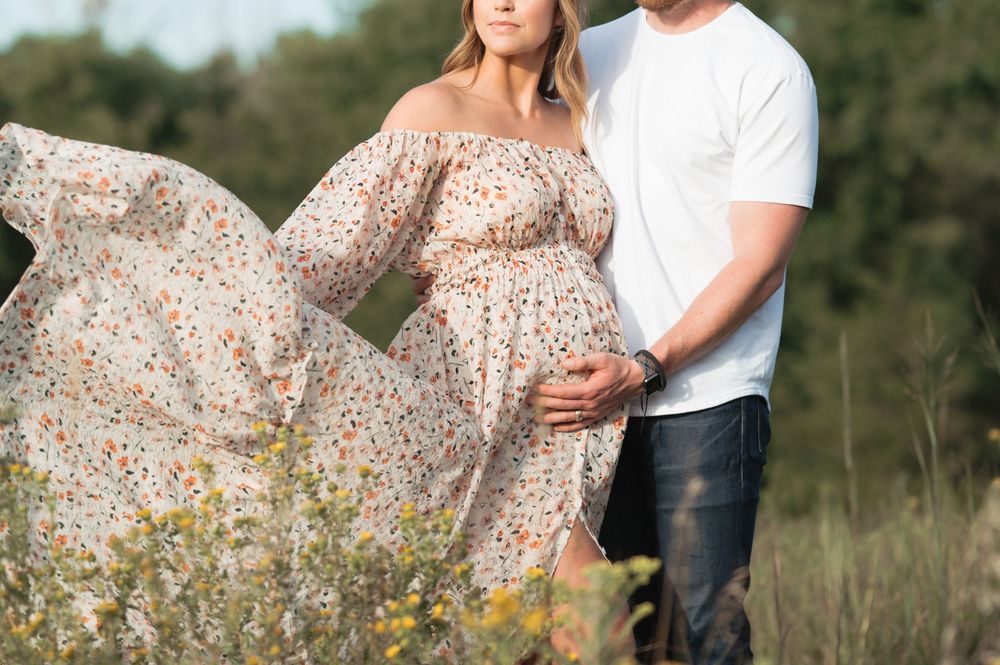 Whimsical maternity photo session in Sioux Falls with soft light and a flowy dress.