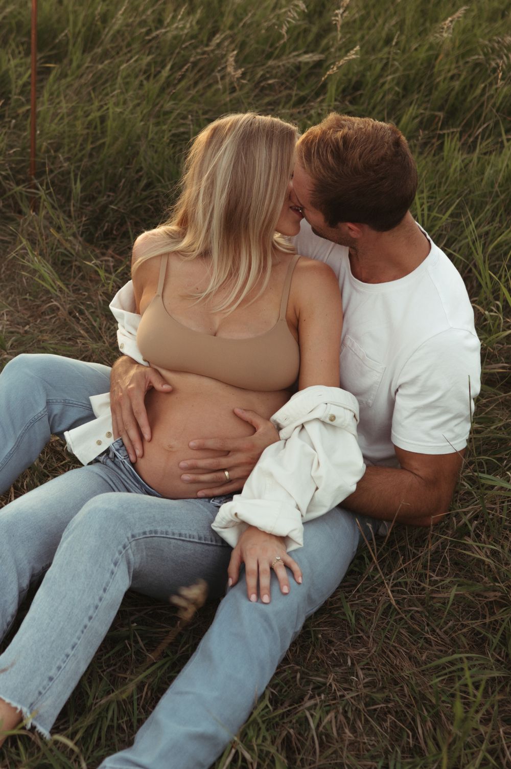 Raw outdoor maternity session in Sioux Falls with natural posing and soft evening light.