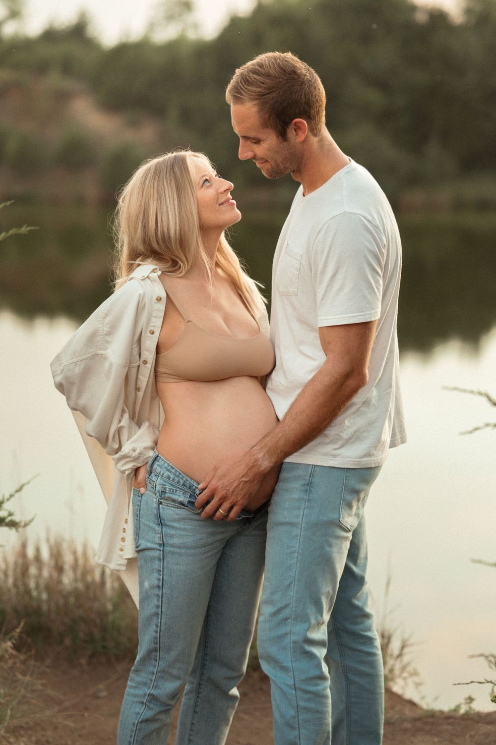 Intimate outdoor maternity session in Sioux Falls with soft golden light and a raw, natural feel.