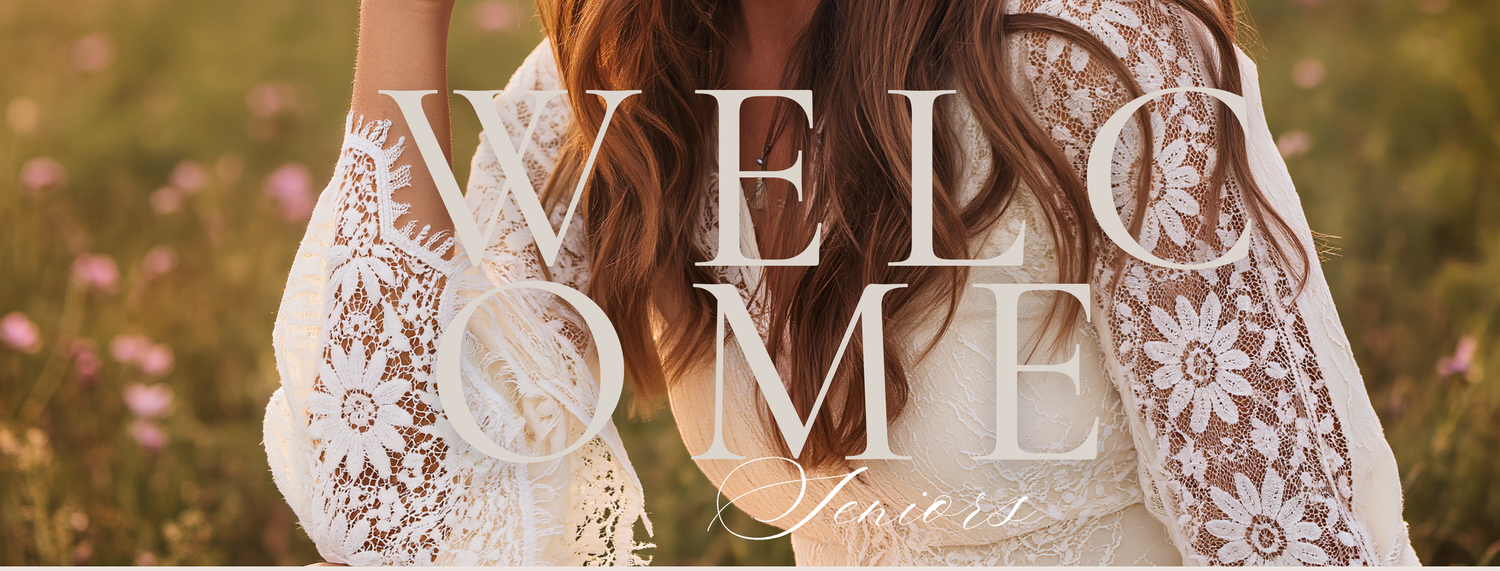 Woman in white lace dress standing in a flower field with a welcome sisters overlay text.