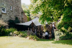 Wedding ceremony surrounded by fairy lights in Cornwall.