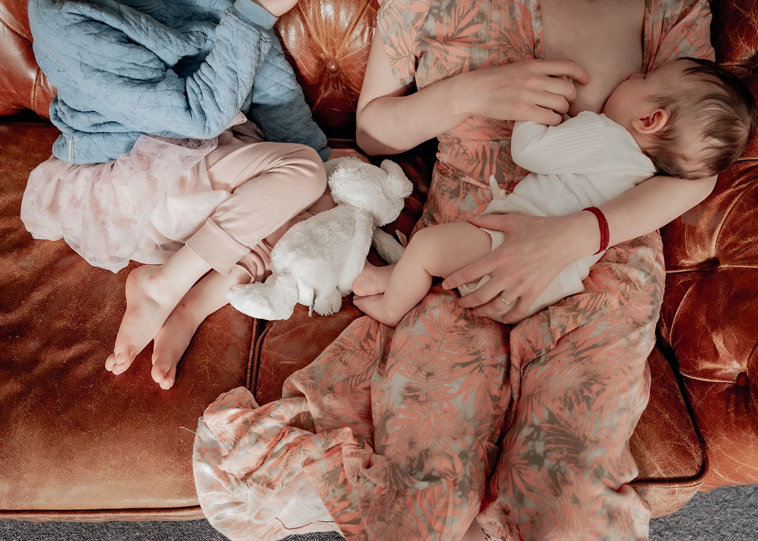 Mother feeding newborn baby during portrait session