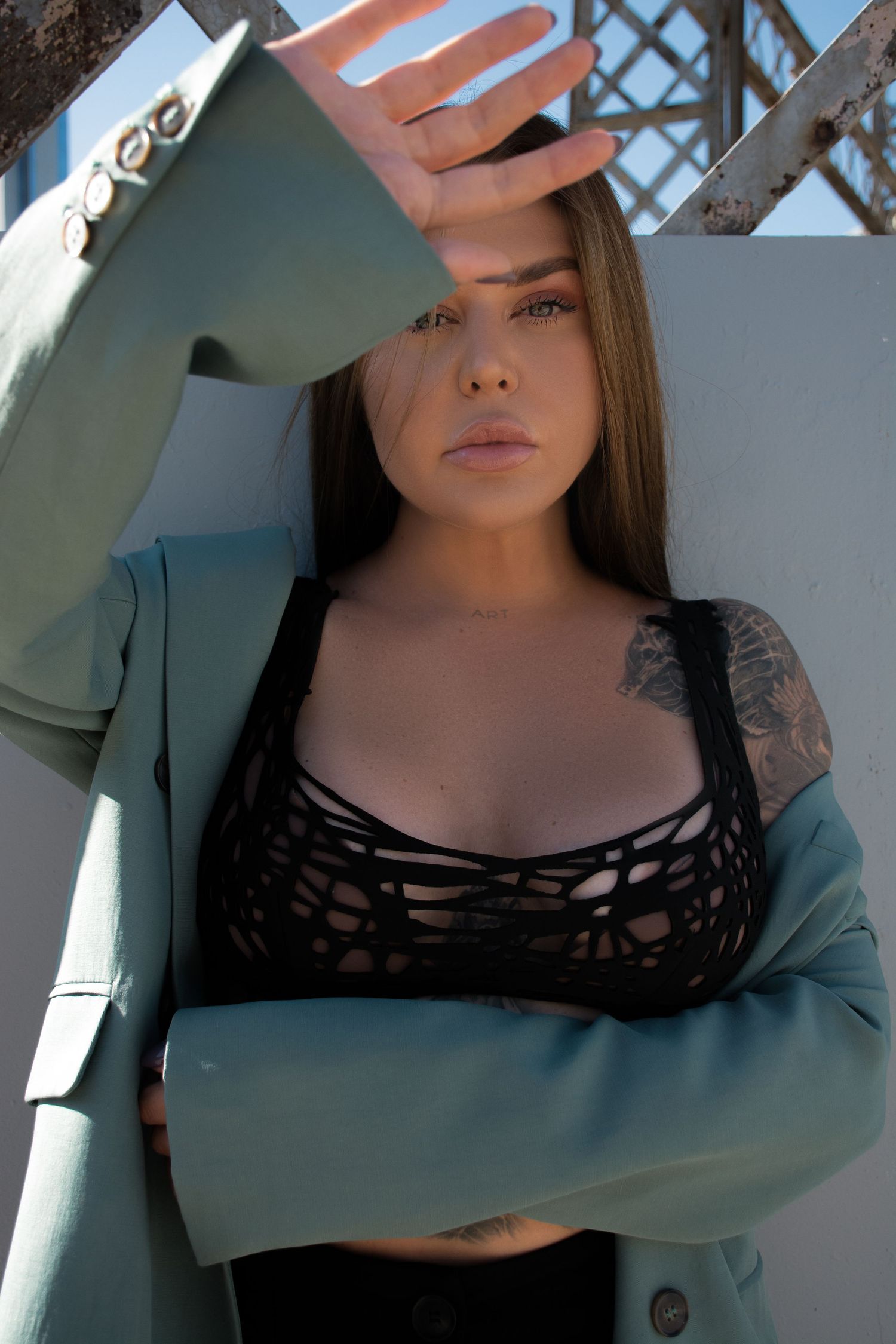 Fashion portrait series in natural light showing poses in a black strappy top.