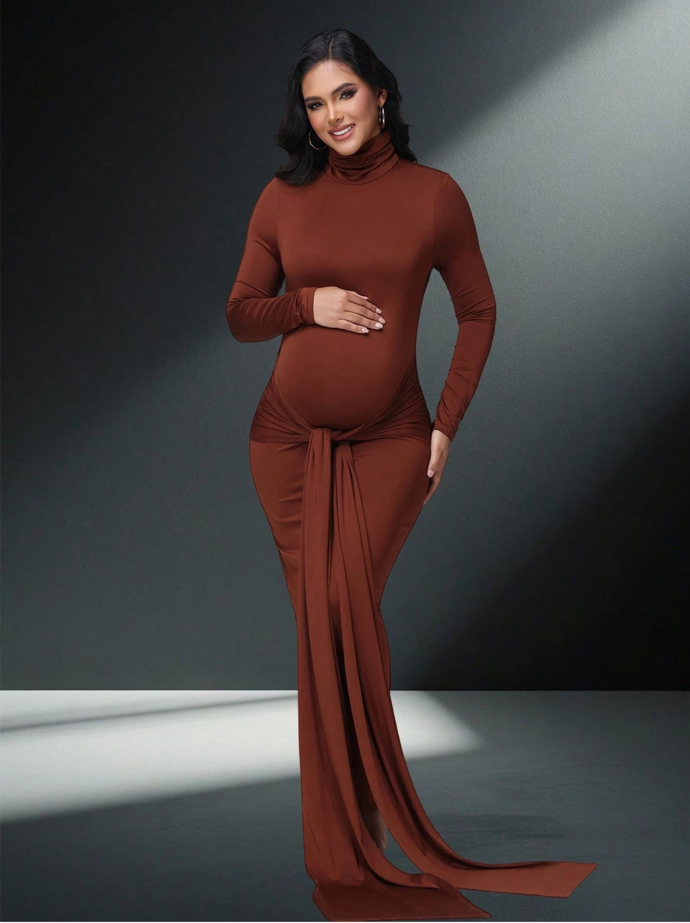 Pregnant woman wearing a rust brown turtleneck long sleeve maternity maxi dress with elegant train detail.