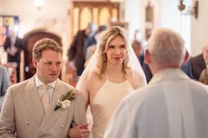 Bride and groom standing before the officiant during their church wedding ceremony.