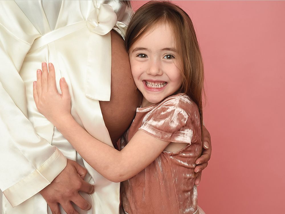 Mother and daughter with baby bump on pink studio backdrop. Photography by Abigail's Studio