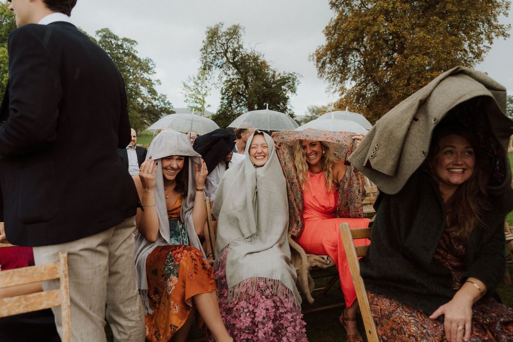 Wedding guests mingle and socialize during an outdoor garden celebration.