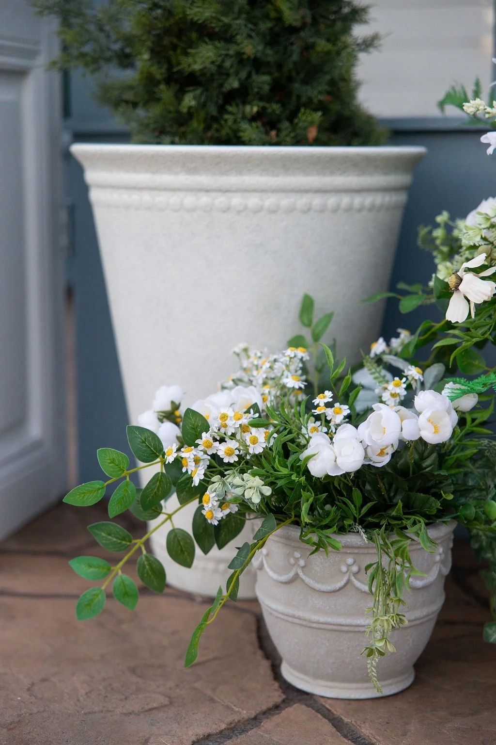 A sequence of photos showing a charming white garden shed decorated with climbing vines and floral arrangements.