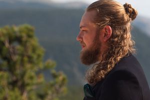 Wedding couple exchanging vows on a scenic mountain deck with forest views.