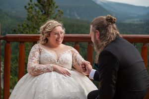 Newlyweds share emotional moments during their mountain-top wedding ceremony.