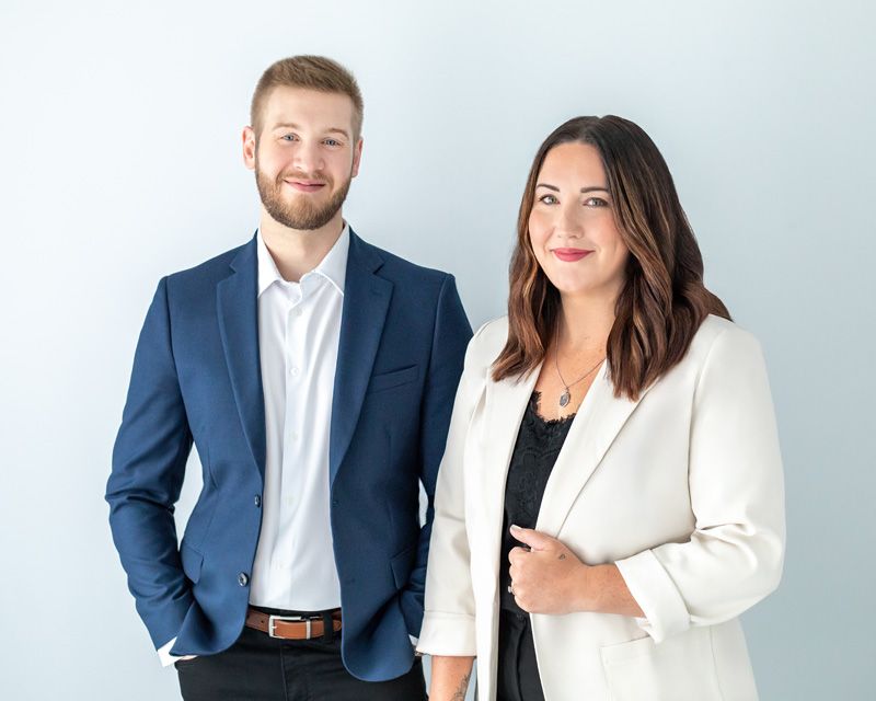 Real estate team in a personal branding photo with a neutral background