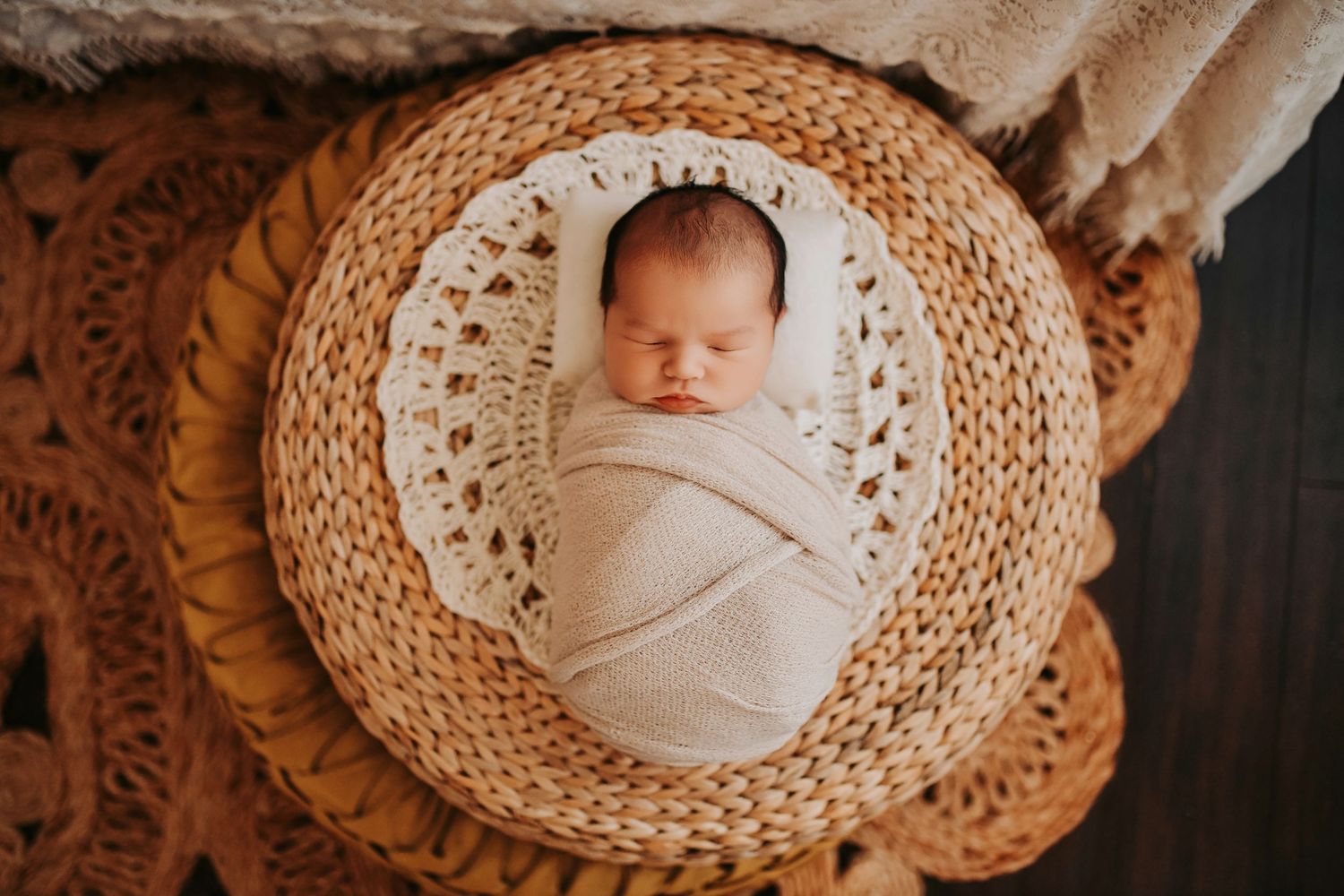 Lifestyle newborn photo of baby lying comfortably on a bed
