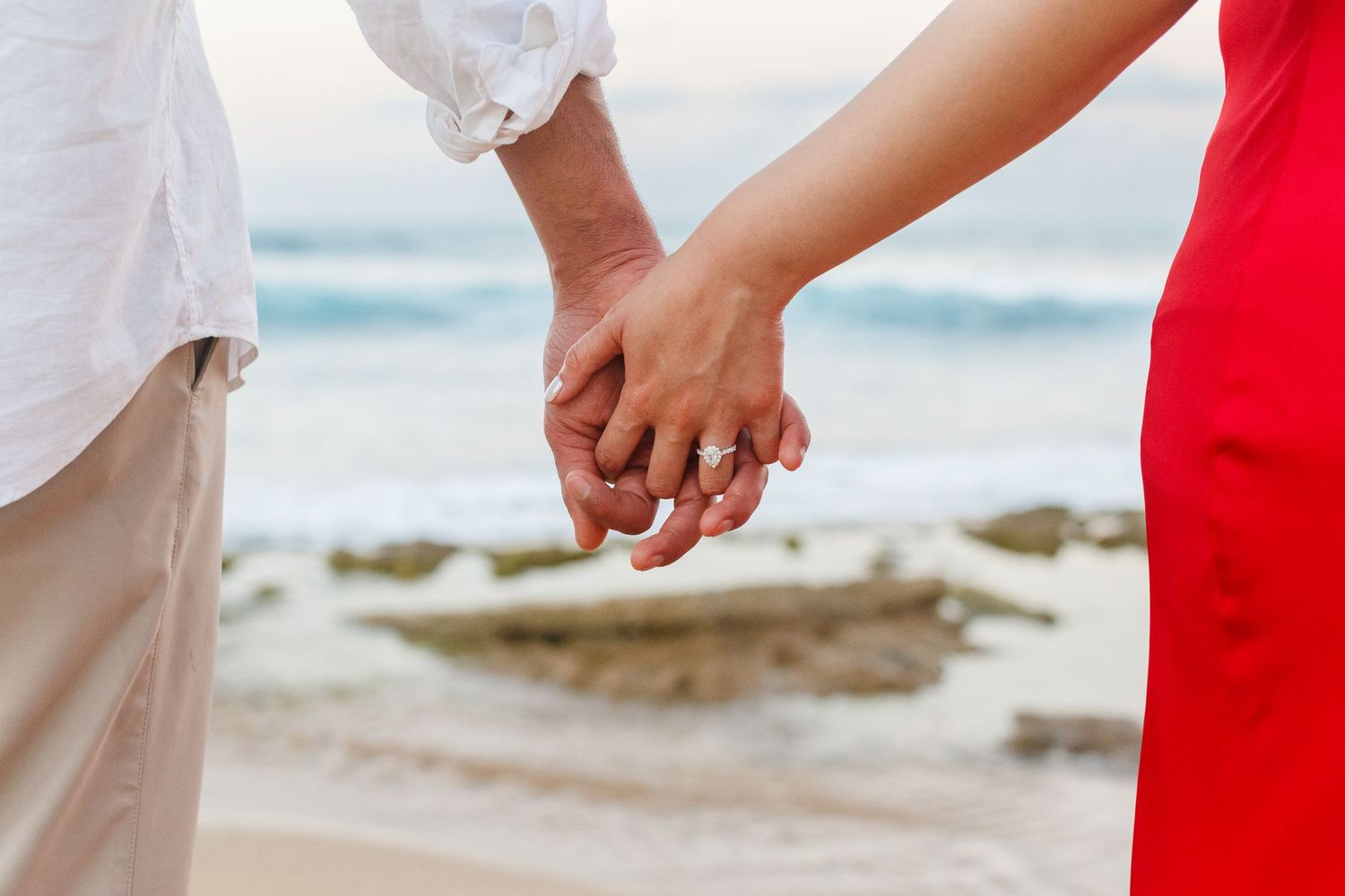 Couples portrait. Clasped hands. On the beach at Kikita Beach in Dorado, Puerto Rico.