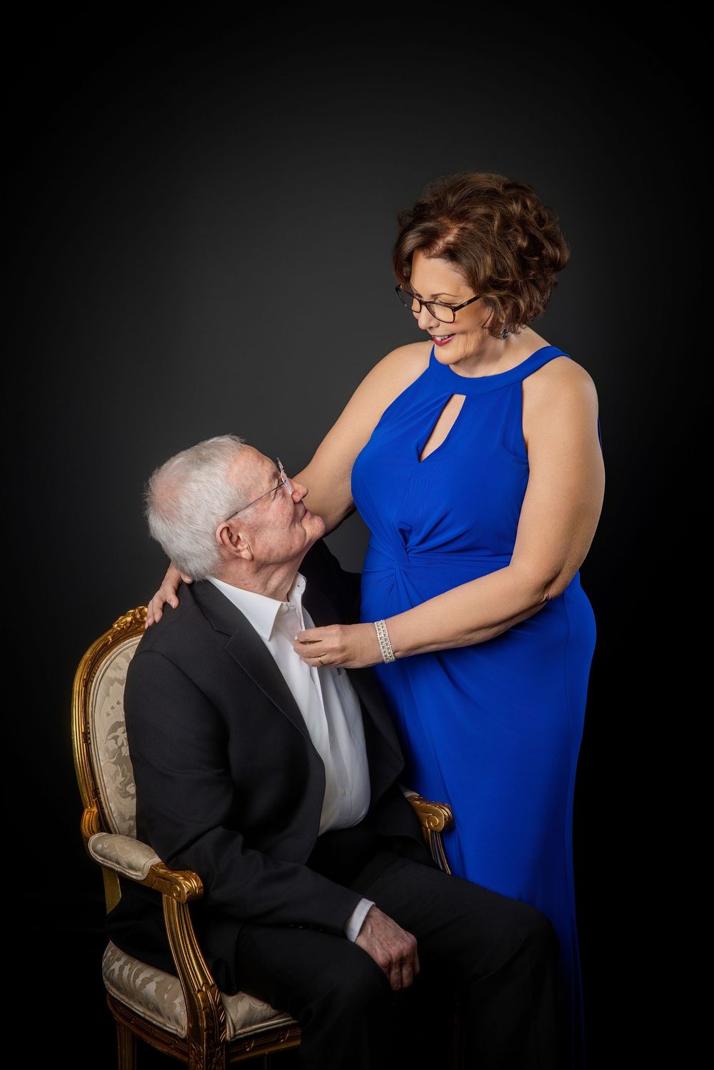 Romantic studio portrait session featuring a couple in formal attire against dark background Knoxville TN couple photography session.