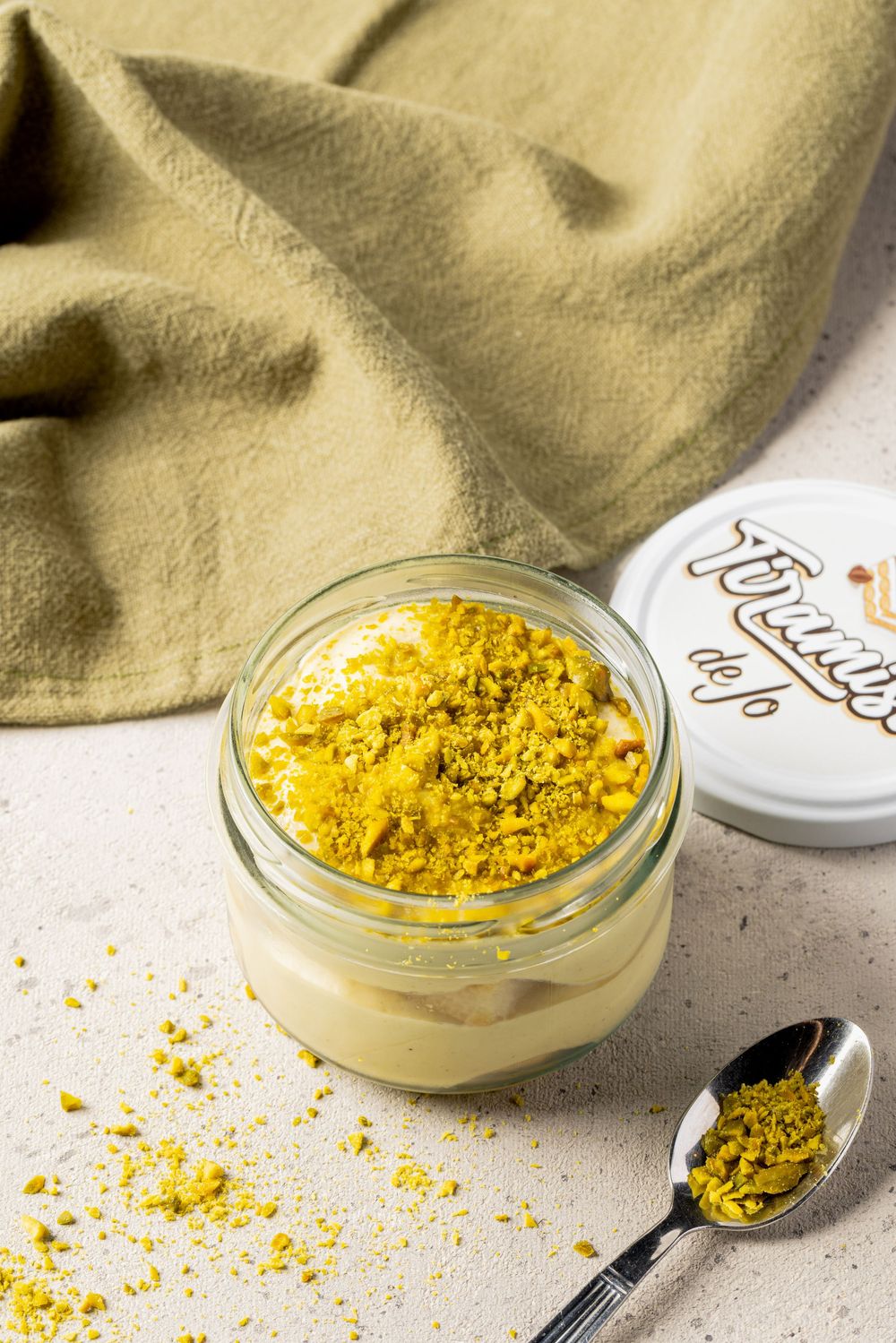 Four sequential photos showing bright yellow nutritional yeast flakes in small glass bowls with measuring spoons.