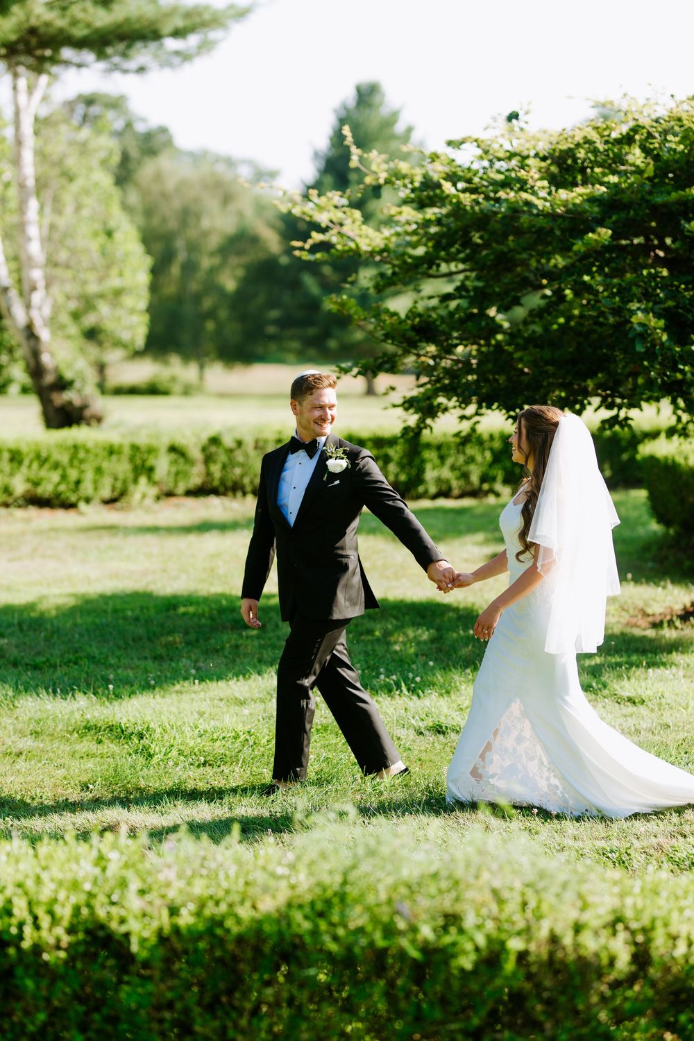 Candid NJ & NY Jewish wedding moment of bride and groom walking together, captured by Uri Arnson Wedding Photography.