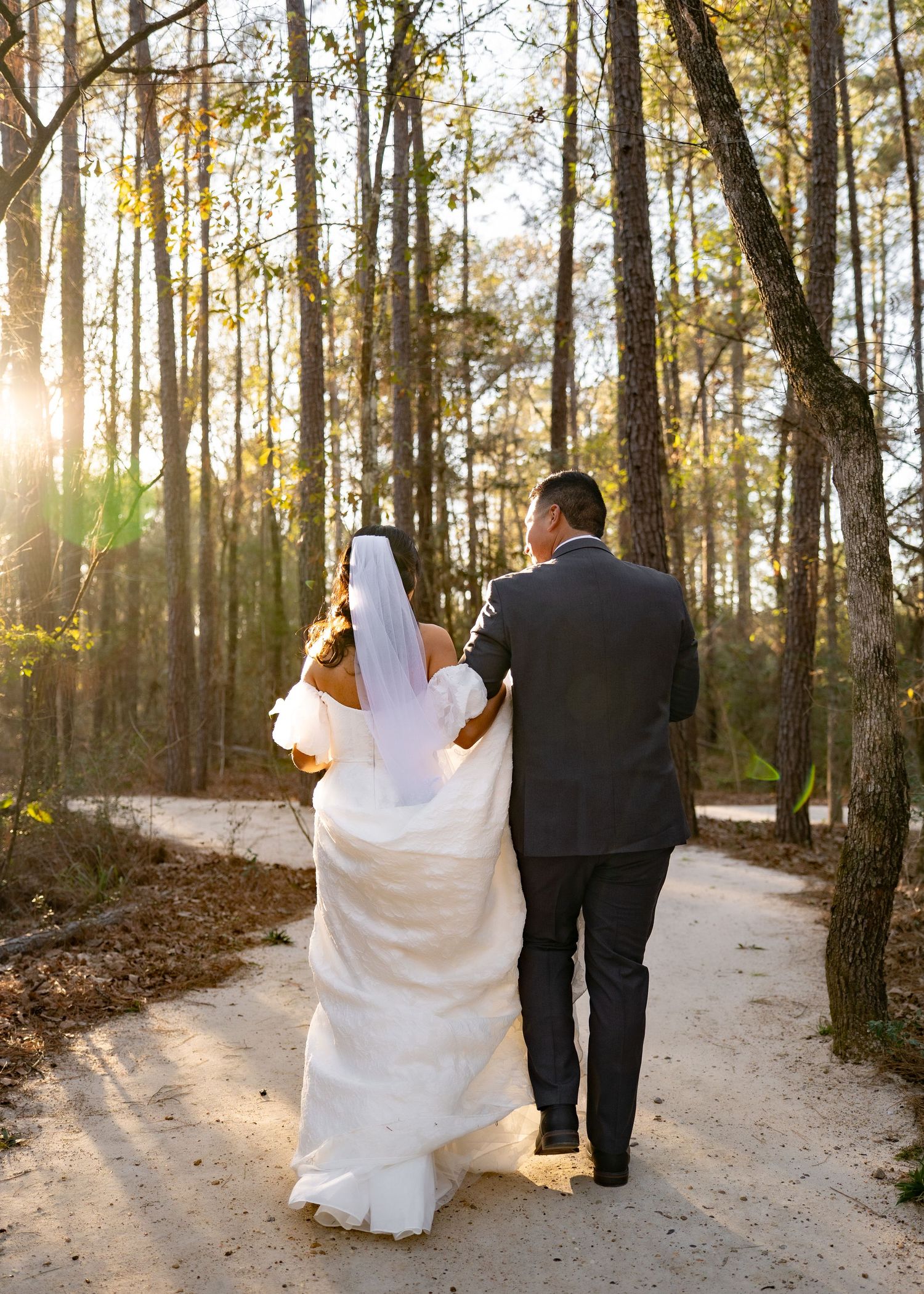 Candid moment of couple laughing together in dense Texas woods at their elopement