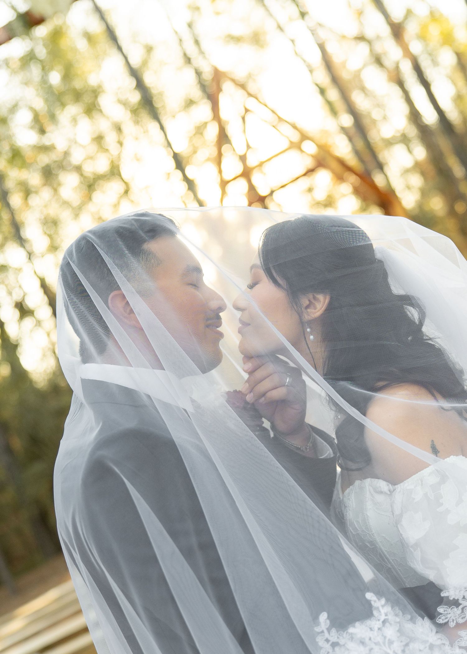 Couple sharing intimate moment in forest during golden hour of their Montgomery Texas elopement