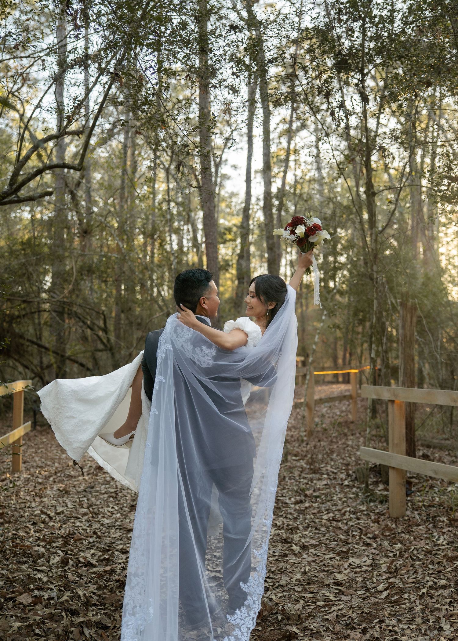 Couple walking through forest path holding hands during intimate Montgomery Texas elopement