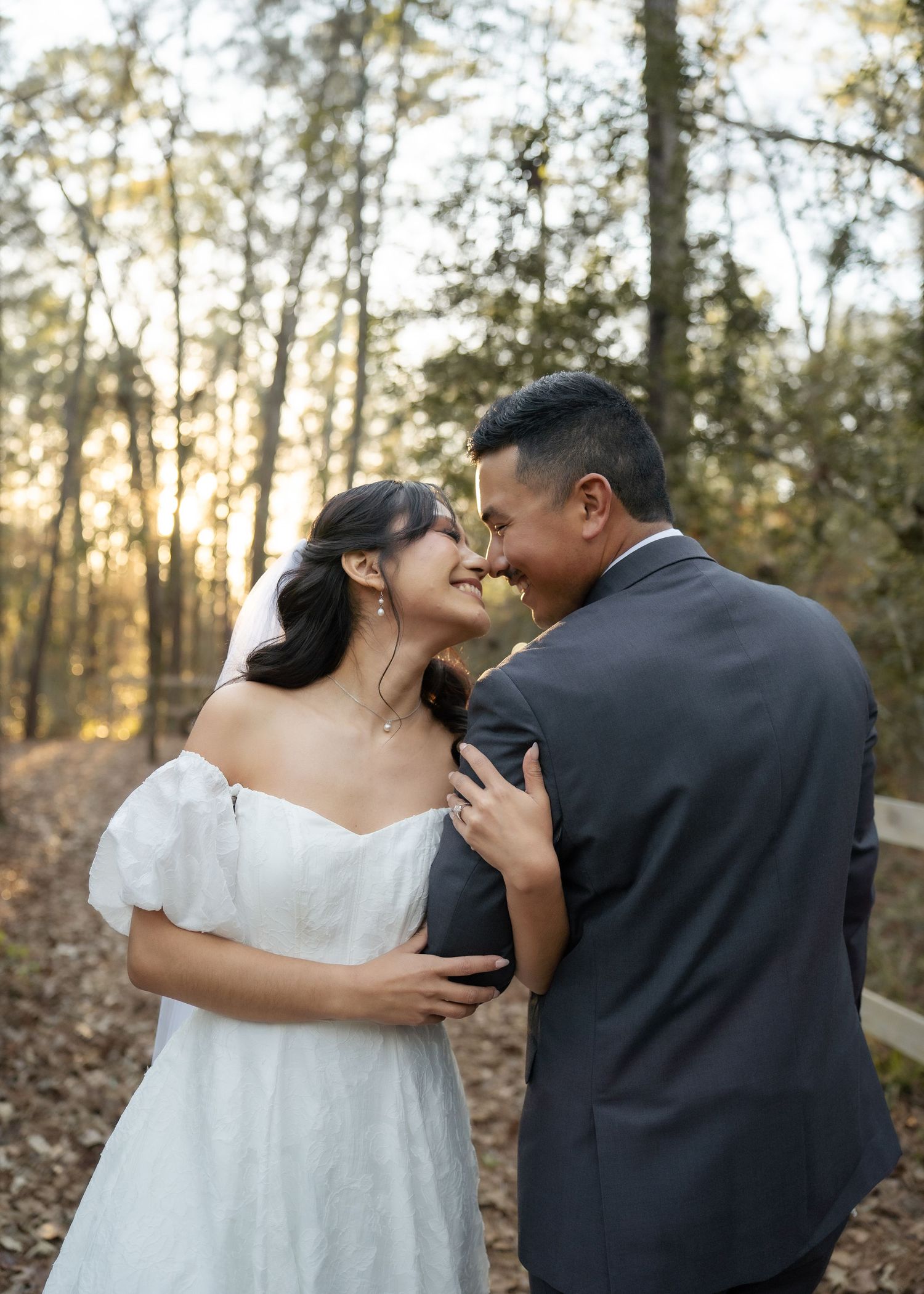 Couple walking through forest path holding hands during intimate Montgomery Texas elopement