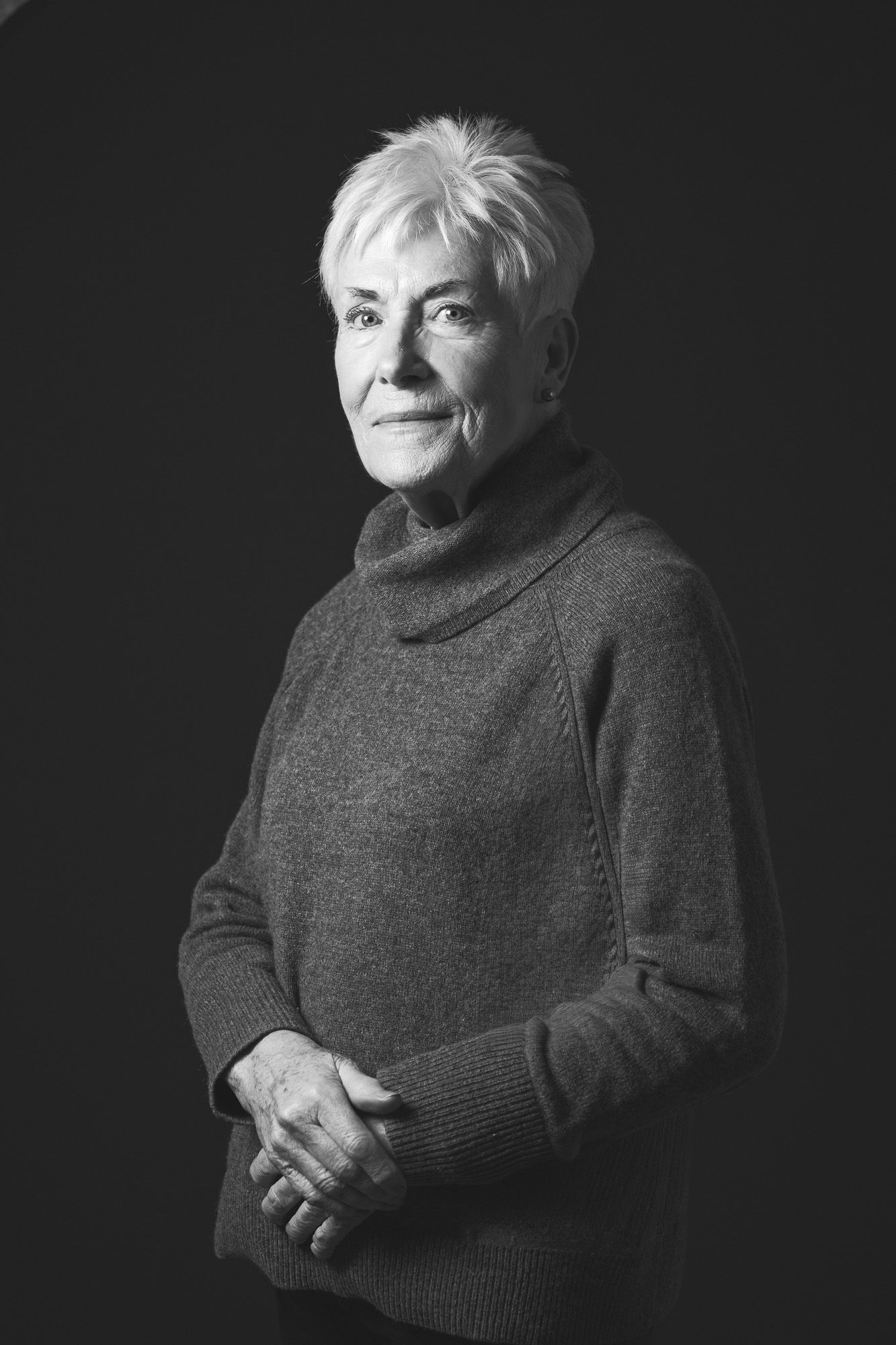 black and white classic timeless portrait of an older woman in a grey jumper taken by N-lite photography in a studio in King's Lynn, Norfolk