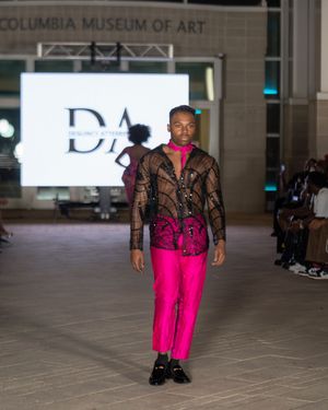 Hot pink pants paired with black lace top displayed during fashion show at Columbia Museum.