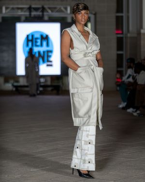 All-white utility wear ensemble presented at Columbia Museum fashion show.