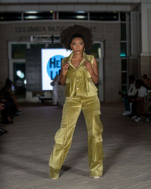 Yellow cargo pants ensemble showcased on runway at Columbia Museum fashion show.