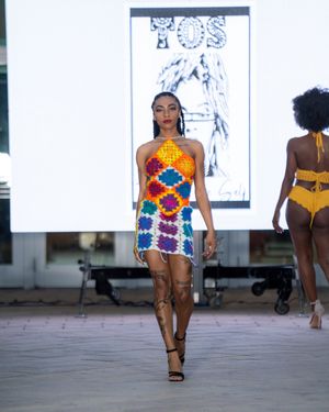 Fashion models showcase colorful patterned swimwear on the runway at Columbia Museum of Art.