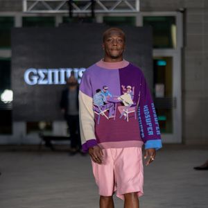 Model presents purple and pink color-blocked outfit during fashion show at Columbia Museum.