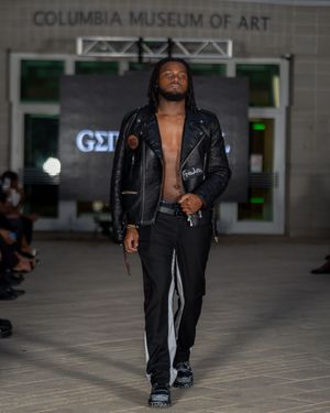 Fashion show featuring black leather outfits on the runway at Columbia Museum of Art.